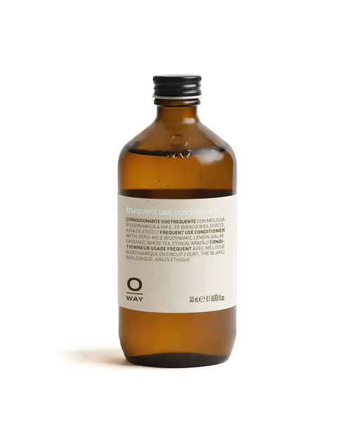 Brown bottle of OWAY frequent use conditioner on a white background