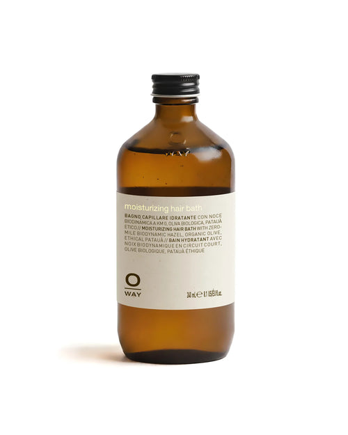 Brown bottle of OWAY moisturizing hair bath on a white background