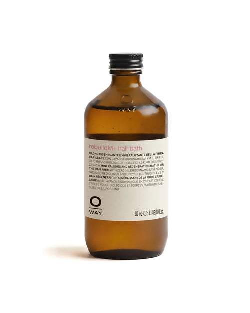 Brown OWAY bottle of rebuildM+ hair bath on a white background