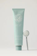 Green Roz foundation mask container on a light gray background