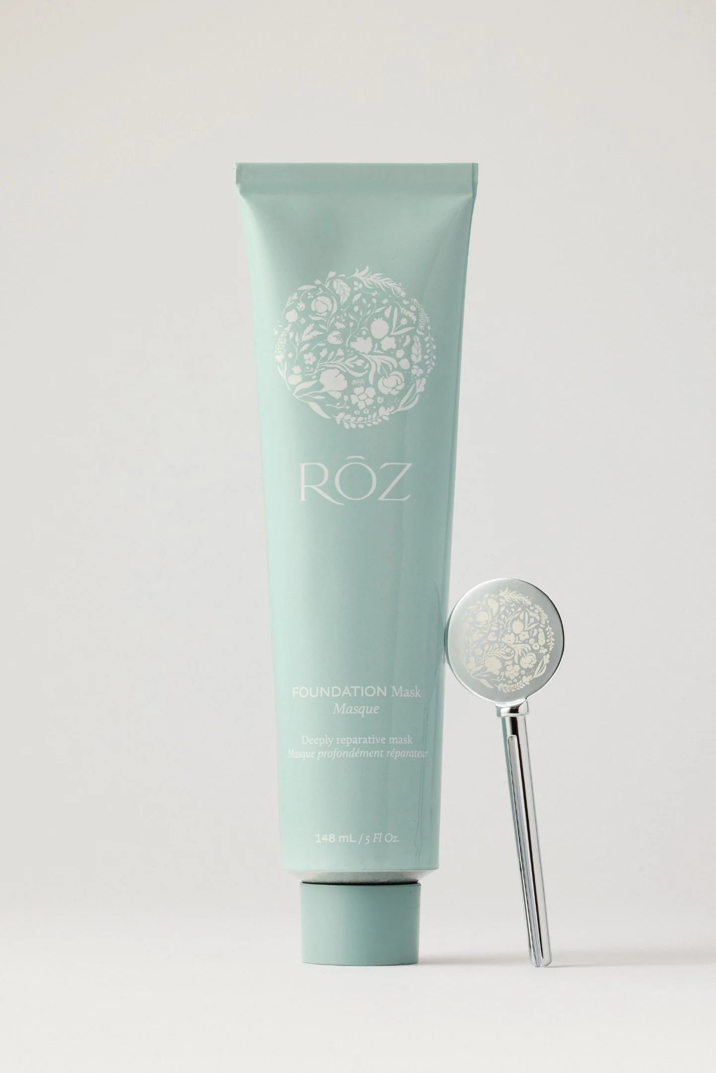 Green Roz foundation mask container on a light gray background