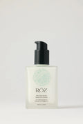 White bottle of ROZ milk hair serum with black top on white background