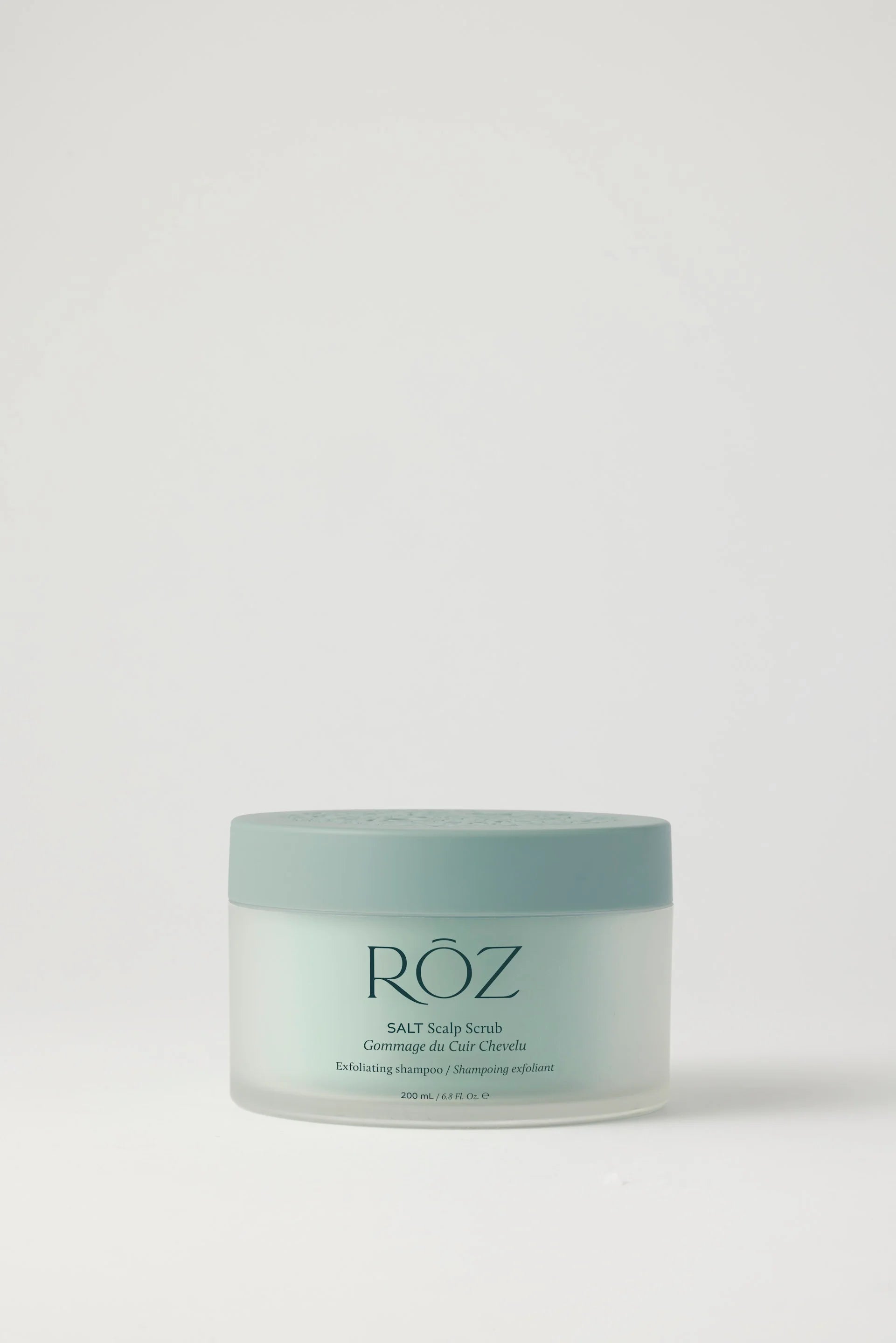 Green container of ROZ Salt Scrub on white background