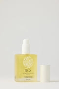 Bottle of Roz hair serum product on a light gray background