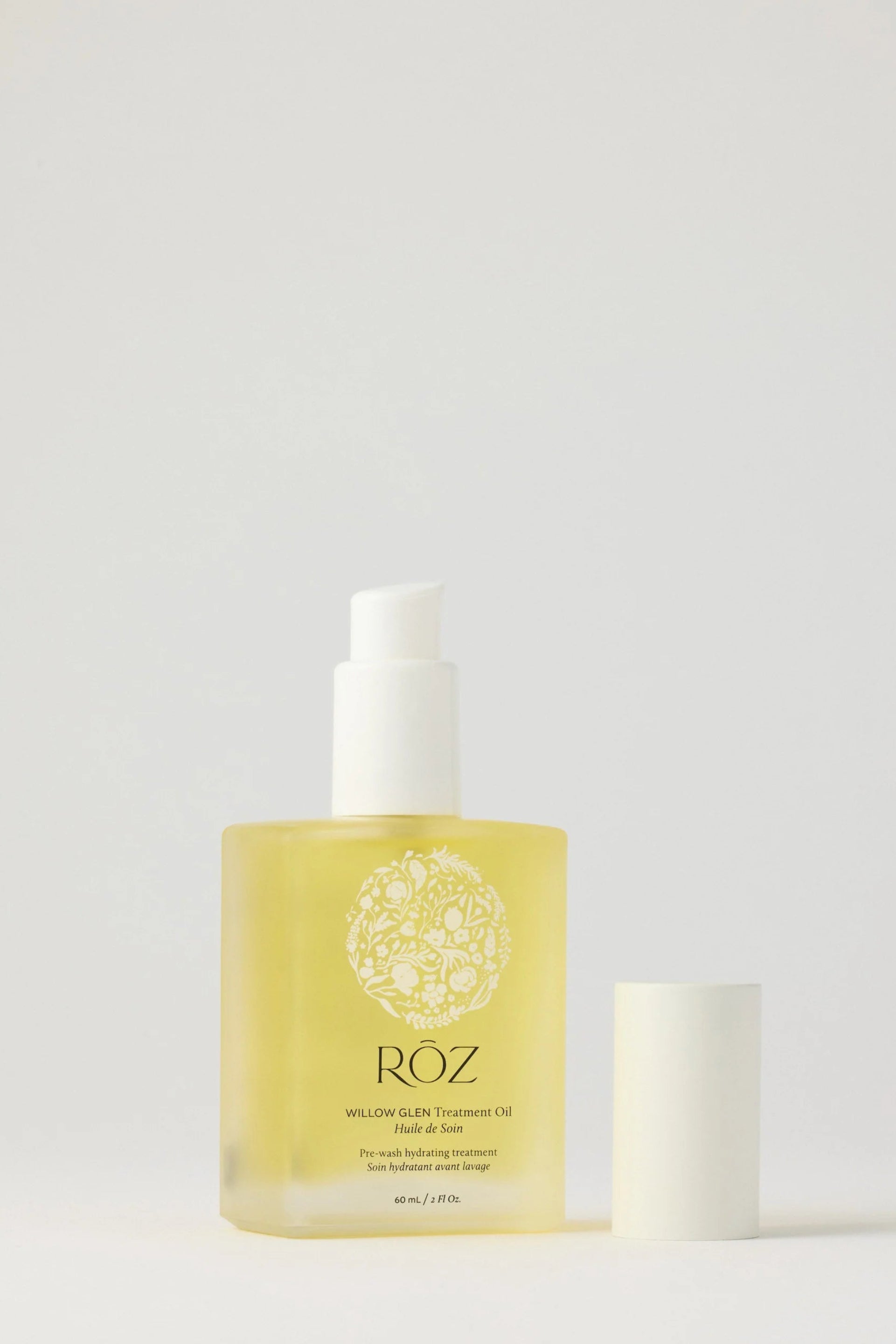 Bottle of Roz hair serum product on a light gray background